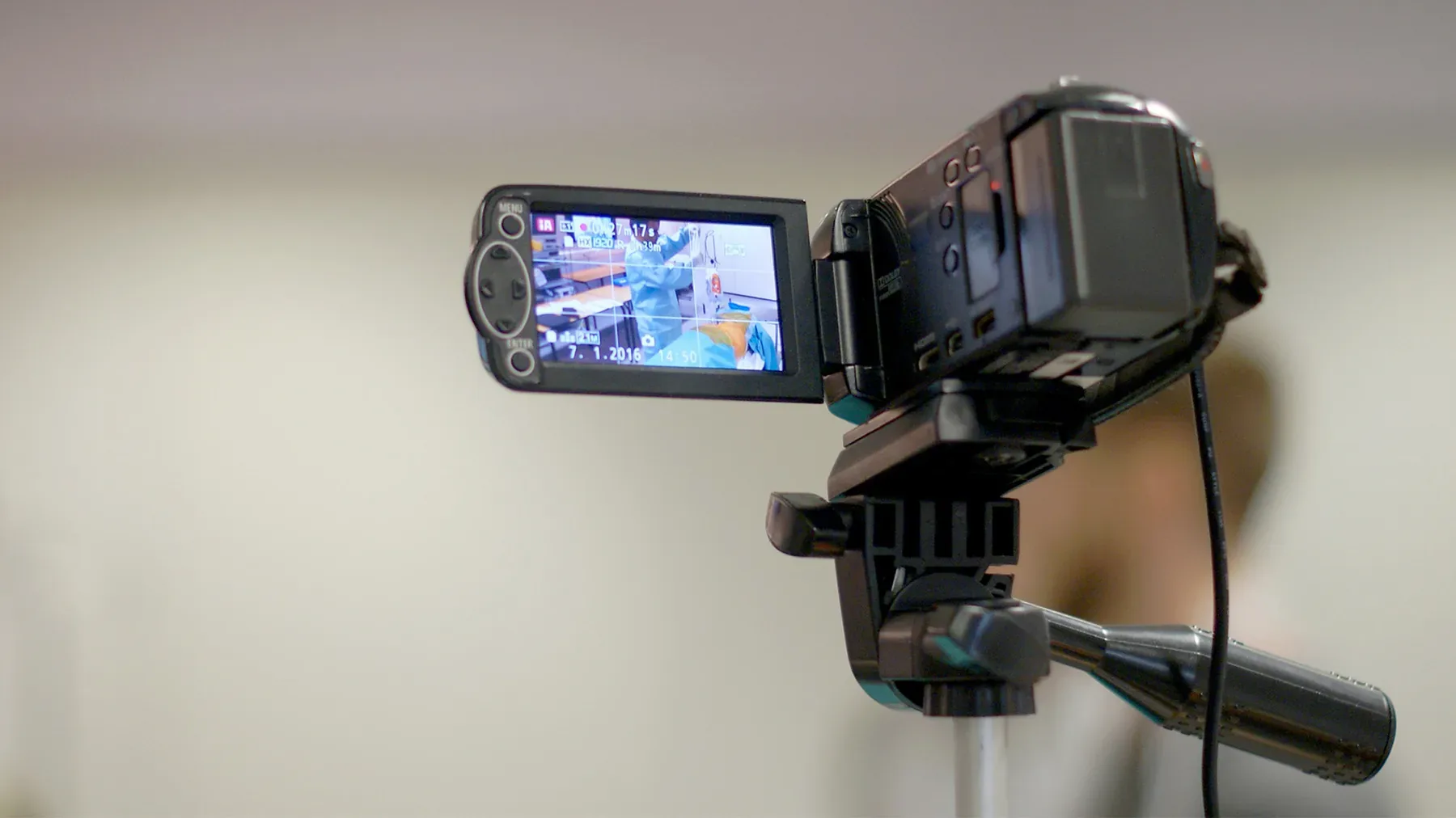 Video camera on tripod capturing surgical session